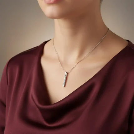 model wearing line shaped silver pendant with cubic zirconia