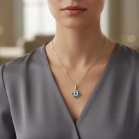 model wearing silver pendant eye shaped with 6mm round evil eye
