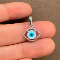 silver pendant eye shaped with 6mm round evil eye displayed on hand