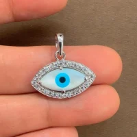 silver pendant with 7x14mm eye shaped cluster evil eye displayed on hand