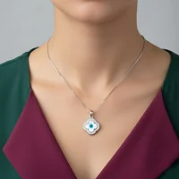 model wearing silver pendant with 10mm clover shaped cluster evil eye