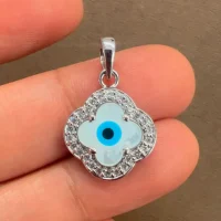 silver pendant with 10mm clover shaped cluster evil eye displayed on hand