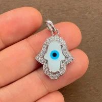 silver pendant with 9x13mm hamsa shaped cluster evil eye displayed on hand