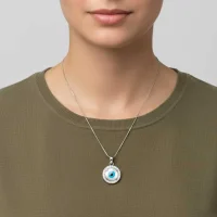 model wearing silver pendant with 10mm round shaped cluster evil eye