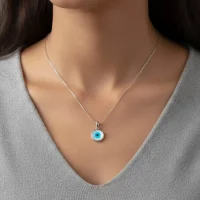 model wearing silver pendant with 10mm round evil eye