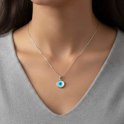 model wearing silver pendant with 10mm round evil eye