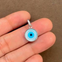 silver pendant with 10mm round evil eye displayed on hand