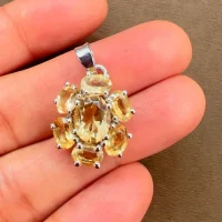 silver pendant with 7x9 mm & 6x4 mm oval citrine displayed on hand