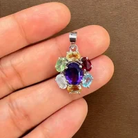 silver pendant with 7x9 mm & 6x4 mm oval multi gemstone displayed on hand