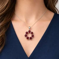 model wearing silver pendant round shaped with 6mm round garnet