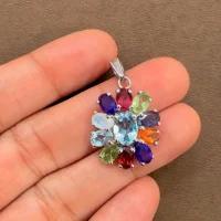 silver pendant flower shaped with multi gemstone displayed on hand