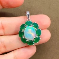silver pendant with 10x12 mm oval opal and 6x4 mm green onyx gemstone displayed on hand