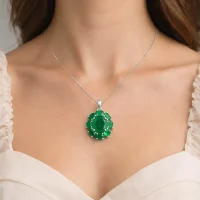 model wearing silver pendant with 10x12 mm and 6x4 mm oval green onyx gemstone