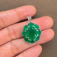 silver pendant with 10x12 mm and 6x4 mm oval green onyx gemstone displayed on hand