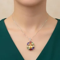 model wearing silver pendant with 10x12 mm oval citrine and 6x4 mm multi gemstone