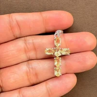 silver pendant cross design with 4x6mm oval citrine displayed on hand
