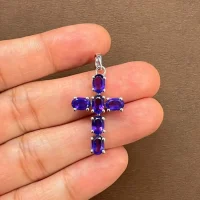 silver pendant cross design with 4x6mm oval amethyst displayed on hand