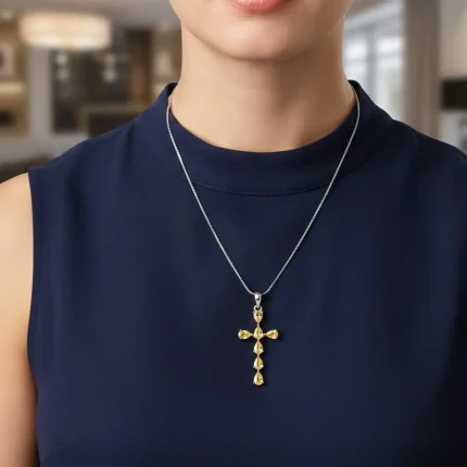 model wearing silver pendant cross design with 4x6mm pear citrine