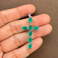 silver pendant cross design with 4x6mm pear green onyx displayed on hand