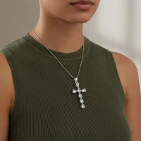 model wearing silver pendant cross design with 4x6mm pear rainbow moonstone