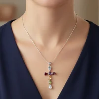 model wearing silver pendant cross design with 4x6mm pear multi gemstone