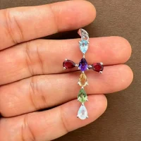silver pendant cross design with 4x6mm pear multi gemstone displayed on hand