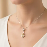 model wearing silver pendant with 5x7 mm oval shaped citrine