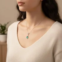 model wearing silver pendant with 5x7 mm oval shaped green onyx