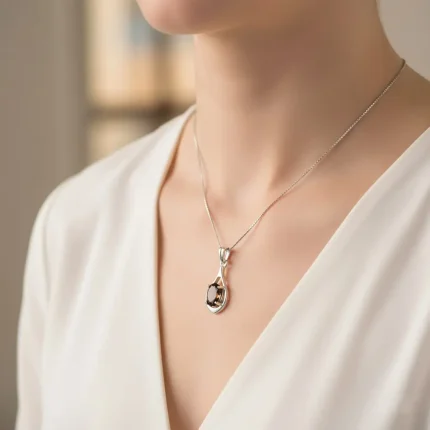 model wearing silver pendant with 5x7 mm oval shaped smoky quartz
