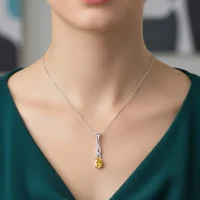 model wearing silver pendant with 5x7 mm oval citrine