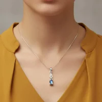 model wearing silver pendant with 5x7 mm oval labradorite