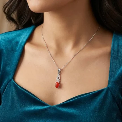 model wearing silver pendant with 5x7 mm oval red onyx cabochon