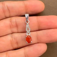 silver pendant with 5x7 mm oval red onyx cabochon displayed on hand