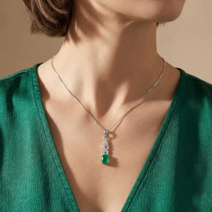 model wearing silver pendant with 5x7 mm oval green onyx cabochon