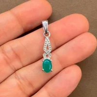 silver pendant with 5x7 mm oval green onyx cabochon displayed on hand