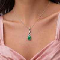 model wearing silver pendant with 5x7 mm oval green onyx