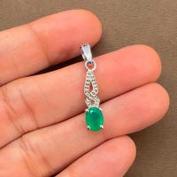 silver pendant with 5x7 mm oval green onyx displayed on hand