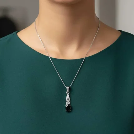 model wearing silver pendant with 5x7 mm oval black onyx