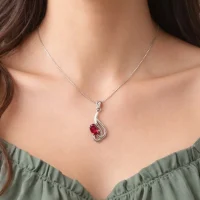 model wearing silver pendant with 5x7 mm oval garnet