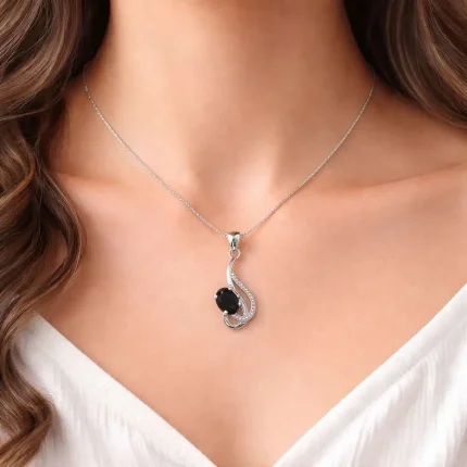 model wearing silver pendant with 5x7 mm oval black onyx