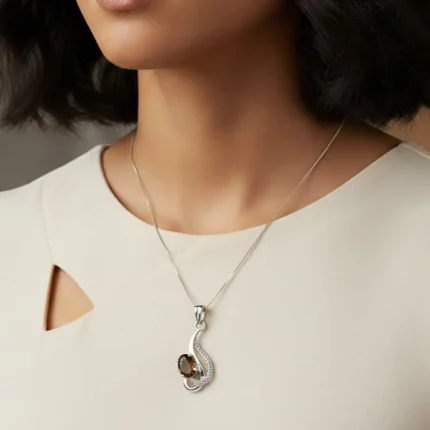 model wearing silver pendant with 5x7 mm oval smoky quartz
