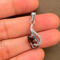 silver pendant with 5x7 mm oval smoky quartz displayed on hand