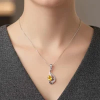 model wearing silver pendant with 5x7 mm oval citrine