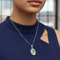 model wearing silver pendant with 5x7 mm oval peridot