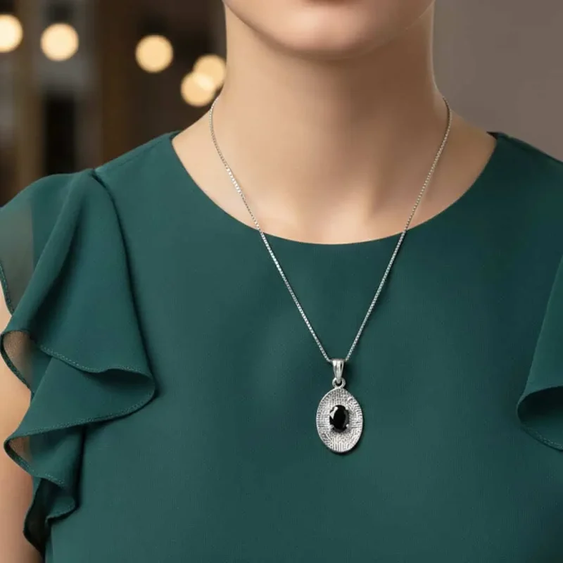 model wearing silver pendant with 5x7 mm oval black onyx