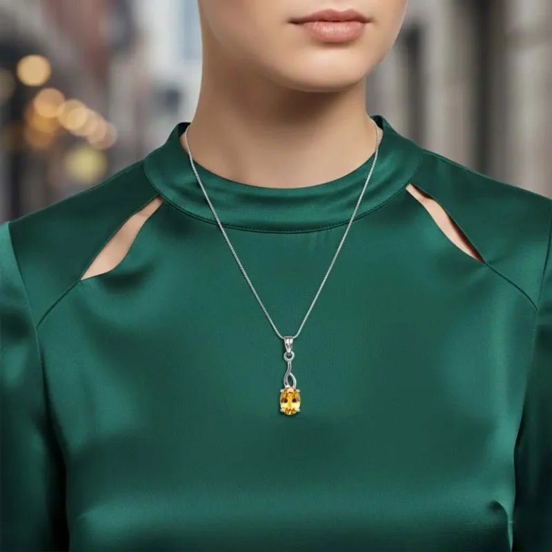 model wearing silver pendant with 5x7 mm oval citrine