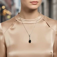 model wearing silver pendant with 5x7 mm oval black onyx