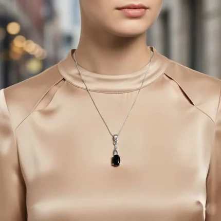 model wearing silver pendant with 5x7 mm oval black onyx
