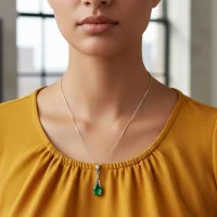 model wearing silver pendant with 5x7 mm oval green onyx