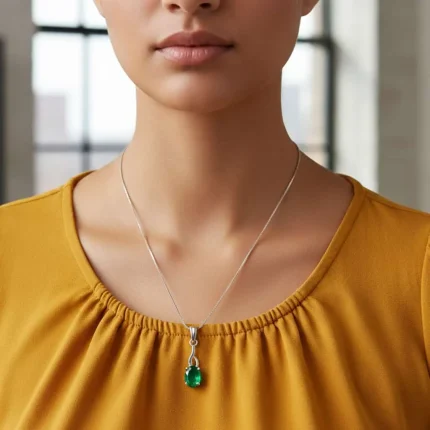 model wearing silver pendant with 5x7 mm oval green onyx